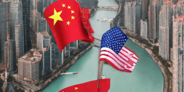 US and Chinese flags over Hong Kong skyline; new executive order impacts tech investments in China. - Supply Chain News