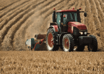 A government-aided tractor assisting farmers in the field.