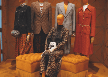 Mannequins in Gucci clothing, showcasing leopard print and tailored suits. Asian fashion influence. - Supply Chain News