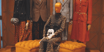 Mannequins in Gucci clothing, showcasing leopard print and tailored suits. Asian fashion influence. - Supply Chain News