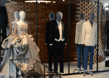Luxury menswear and womenswear displayed on mannequins in a high-end retail space. Brands leasing significant space. - Supply Chain News