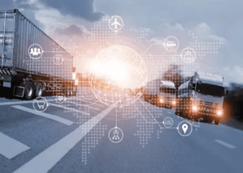 Trucks on highway with digital logistics network overlay. Suttons International and LogChain partnership. - Supply Chain News