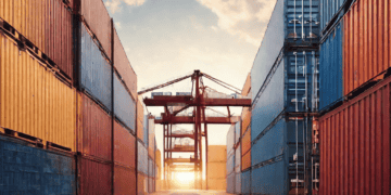 A road full of shipping containers at sunset, showcasing efficient logistics operations.