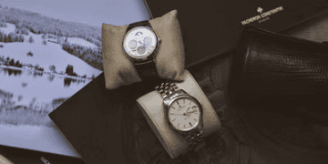Two rare Geneva watches sitting on top of a book.