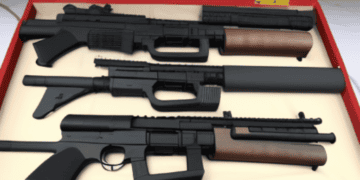 A collection of Chinese firearms displayed in a case.