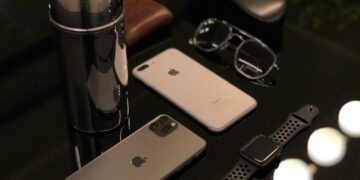 A group of iPhone cell phones and glasses on a table in China