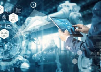 Person using tablet to monitor industrial AI systems, illustrating international AI regulations. - Supply Chain News