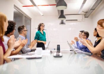 Business team applauds a presenter during a meeting. - Supply Chain News