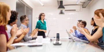 Business team applauds a presenter during a meeting. - Supply Chain News