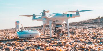 Drone and remote control on a shell-covered beach. - Supply Chain News