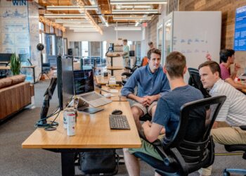 Team of coworkers collaborating on projects in a modern office, optimizing workflows to improve working capital. - Supply Chain News