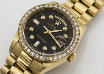 Close-up of a gold Rolex Day-Date watch with diamond bezel and black dial. "Friday" is visible on the day display. - Supply Chain News