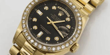 Close-up of a gold Rolex Day-Date watch with diamond bezel and black dial. "Friday" is visible on the day display. - Supply Chain News