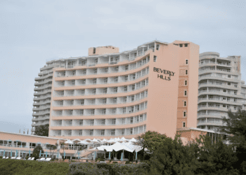 Beverly Hills Hotel exterior shot. Peach-colored building with balconies. - Supply Chain News