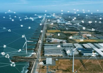 Aerial view of a coastal industrial park using wind turbines and blockchain technology for enhanced supply chain management. - Supply Chain News