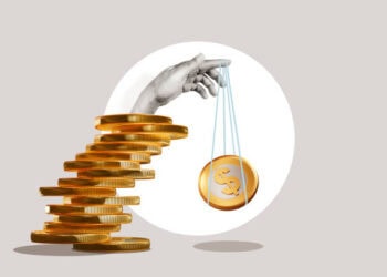 Hand balancing stack of gold coins and a single coin on a string; illustrating supply chain resilience and cost-effectiveness. - Supply Chain News