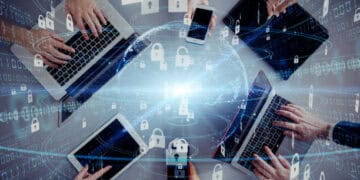 Multiple hands using laptops, tablets, and smartphones, illustrating global cybersecurity and technological growth. - Supply Chain News