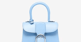 Light blue leather handbag with a silver buckle. Example of quiet luxury. - Supply Chain News