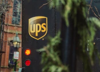 Rear view of a UPS delivery truck, license plate R22-048, showcasing the UPS logo. - Supply Chain News