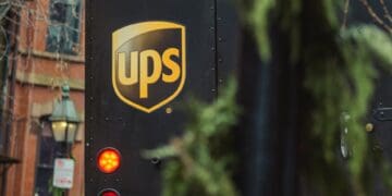 Rear view of a UPS delivery truck, license plate R22-048, showcasing the UPS logo. - Supply Chain News