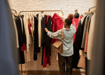 Woman browsing pre-loved luxury clothing in a UAE boutique. - Supply Chain News