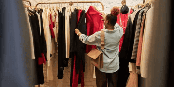 Woman browsing pre-loved luxury clothing in a UAE boutique. - Supply Chain News