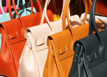 Rows of luxury leather handbags in various colors. - Supply Chain News