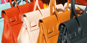 Rows of luxury leather handbags in various colors. - Supply Chain News