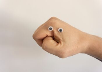 Close-up of a fist with googly eyes, suggesting a frustrated or angry face. - Supply Chain News