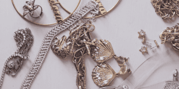 Gold and silver jewelry arranged on a white surface. Luxury necklaces, earrings, and rings are displayed, showcasing a passion for high-end accessories. - Supply Chain News