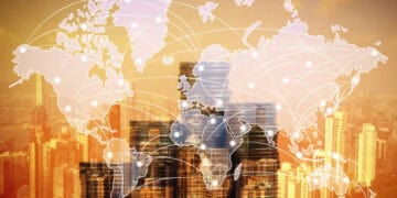 A map of the world with a city in the background.