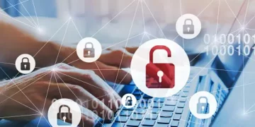 A person typing on a laptop with a padlock on it, highlighting privacy breaches and the EU's concerns.