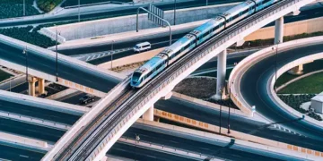 An aerial view of a train traveling on a highway in Kazakhstan.