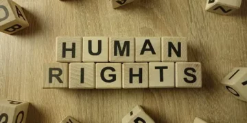 The word human rights spelled out on wooden blocks amid Sudan's RSF senior commanders and US sanctions.
