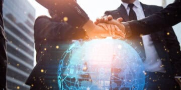 Businesspeople join hands over a digital globe, symbolizing the AfCFTA initiative. - Supply Chain News