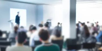 Blurred image of a business presentation with audience. Enterprise risk management concept. - Supply Chain News