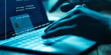 Hacker accessing financial data on laptop, showing "Access Granted" message and credit card details. Cybersecurity threat. - Supply Chain News