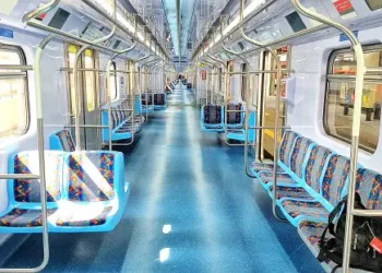 The impact of a transport strike is minimal inside a subway train with blue seats.