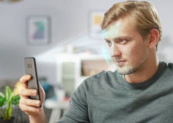 Man using facial recognition on smartphone to combat SIM card fraud in India. - Supply Chain News