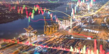 Night view of a busy port with cargo containers and cranes, overlaid with stock market graphs showing India's metal export trends. - Supply Chain News