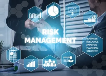 A group of business people sitting around a table discussing Supply Chain Risk Management.