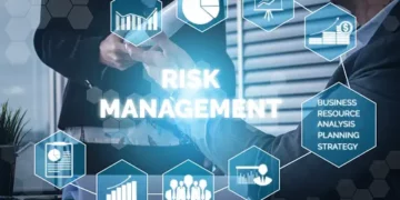 A group of business people sitting around a table discussing Supply Chain Risk Management.