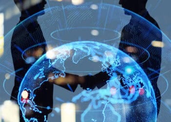 Two business people from South Africa and the United States shaking hands in front of a globe at the AGOA Forum, discussing U.S.-Africa trade relations.