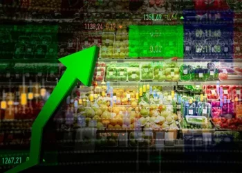 A green arrow pointing up in a grocery store, showcasing the rising food prices.