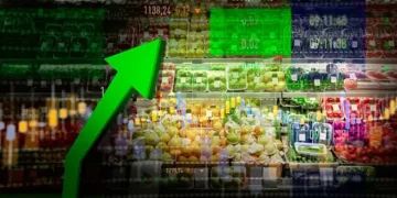A green arrow pointing up in a grocery store, showcasing the rising food prices.