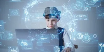 Boy using laptop, surrounded by digital data visualizations. Student data privacy. - Supply Chain News