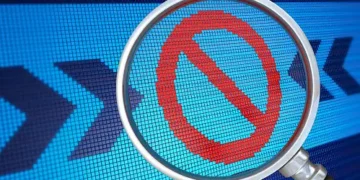Magnifying glass over a prohibited symbol on a digital screen; Canada's ban on WeChat and Kaspersky. - Supply Chain News