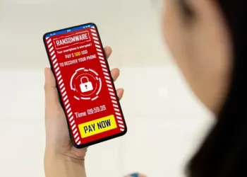 A person holding a phone and engaging in alleged money laundering.