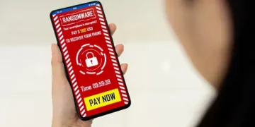 A person holding a phone and engaging in alleged money laundering.