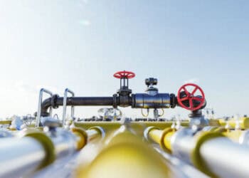A group of pipes and valves in a field, showcasing the impact of increased U.S. natural gas exports on CO2 emissions.